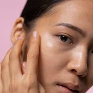 Close-up of a woman with dull and uneven skin receiving gentle skincare treatment for improved radiance and texture