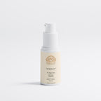 Skincare serum bottle with a white cap on a light gray background