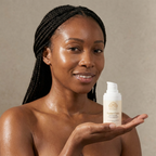 Woman with glass-skin holding Norvia Co. Rested Eyes Dark Circle Cream