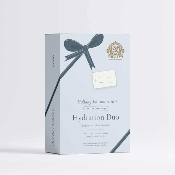 A light blue rectangular product box for the 'Hydration Duo' by Malvina, featuring a dark blue ribbon graphic, a small gift tag, and gold branding details on a clean white background.