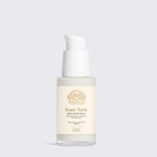 Alpha-Arbutin Serum in a clear glass bottle with white pump and cream label featuring gold Norvia branding