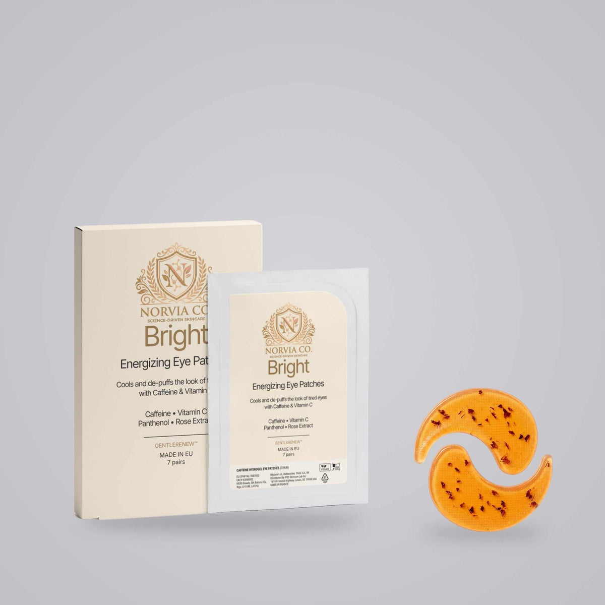 Caffeine Eye Patches in orange hydrogel crescent shapes beside cream and white Bright Energizing Eye Patches packaging