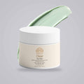 Clay Mask for Pores in a cream-colored jar with a white lid, paired with a pale green clay smear