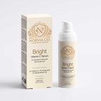 Bright Vitamin C serum set from the Even Tone Routine Set, with a cream box and white pump bottle in gold lettering.
