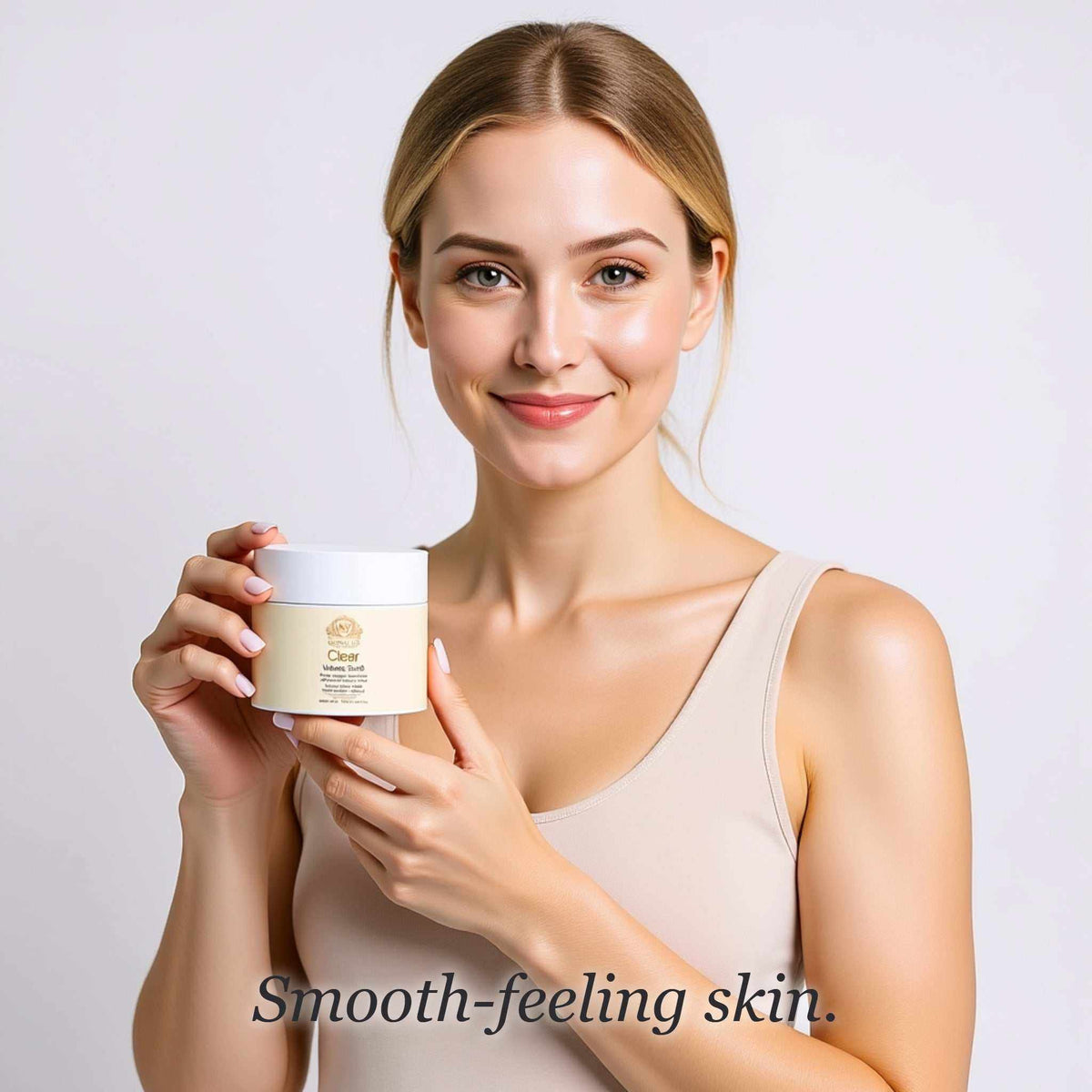 Face and Body Scrub in a cream-colored jar with a white lid, held by a woman; label reads Clear Volcanic Scrub