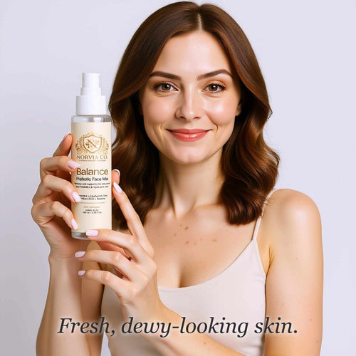 Facial Mist for Dry Skin in a clear spray bottle with a white pump and cream label, held by a woman