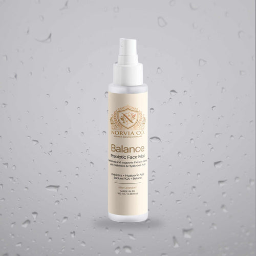 Facial Mist for Dry Skin in a slim white spray bottle with a cream label, gold crest and Balance Prebiotic Face Mist text