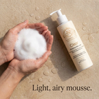 Foam Cleanser for Oily Skin in a cream pump bottle with a white dispenser, shown beside airy white mousse foam