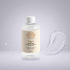 Glycolic Acid Toner in a clear bottle with a cream label, gold detailing, and white cap