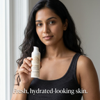 Hyaluronic Acid Serum in a beige pump bottle with a white dispenser, held by a woman wearing a black tank top