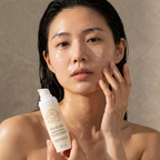 Hyaluronic Acid Serum in a cream pump bottle, shown beside a woman applying the product to her face