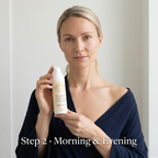 Hyaluronic Acid Serum in a white pump bottle with a cream label, held by a woman wearing a navy top