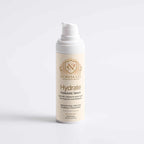 Hyaluronic Acid Serum in a white pump bottle with a cream label, gold crest, and Hydrate branding