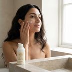Moisturizer for Dehydrated Skin, a light cream applied to the cheek beside a white pump bottle