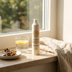 Moisturizer for Dehydrated Skin in a white pump bottle with a beige label, alongside a glass and hair clips