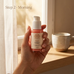 Peptide Serum in a coral-toned bottle with a white pump and cream label, held in one hand