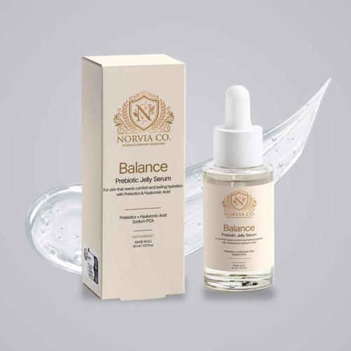 Skin Barrier Serum in a clear dropper bottle with cream label and white pipette beside matching beige box