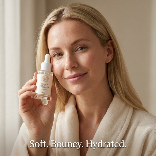 Skin Barrier Serum in a clear dropper bottle with white cap and beige Balance label, held beside a woman's face