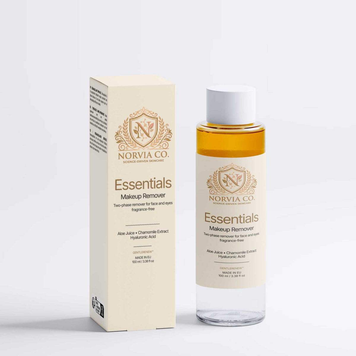 Skin Care Routine Kit featuring a clear, amber two-phase makeup remover bottle and matching cream-colored box with gold detailing
