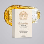 Skin Care Routine Kit with a cream-colored Essentials Routine Set box featuring gold lettering and botanical branding