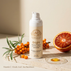 Vitamin C Serum in a cream-colored pump bottle with a gold label, beside sea buckthorn berries and a sliced citrus fruit