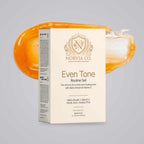 Norvia Co. Even Tone Routine Set, a vitamin C skincare set, box in front of an orange serum and hyaluronic gel swoosh